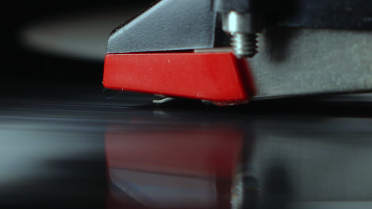 Tonearm needle closeup with spinning black dj vinyl 3
