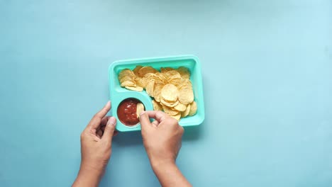 person eating nachos with salsa