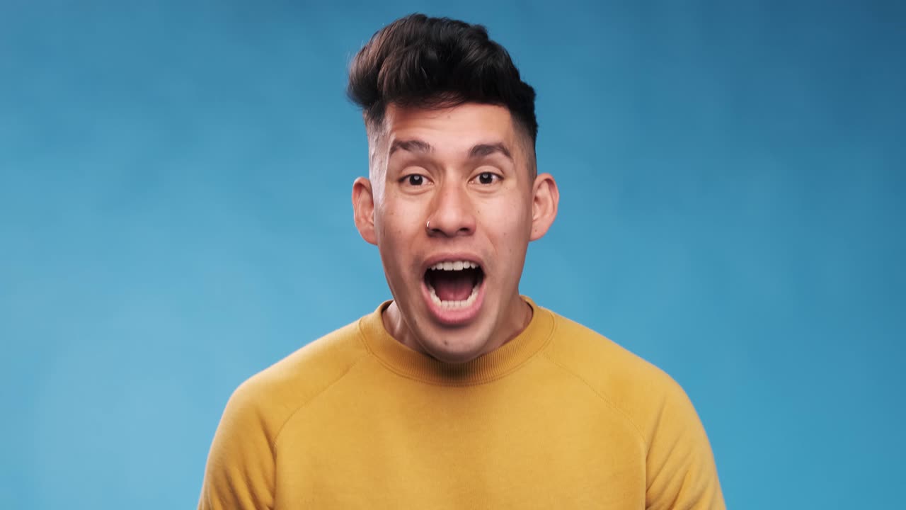Close-up view of a man screaming while standing on an isolated background.