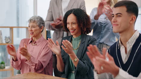 diverse team of professionals clapping and celebrating success at work.