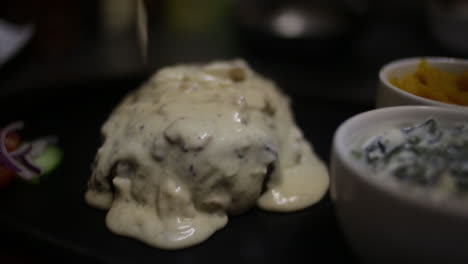 mushroom-sauce-drizzled-over-a-steak-in-a-dark-restaurant-setting