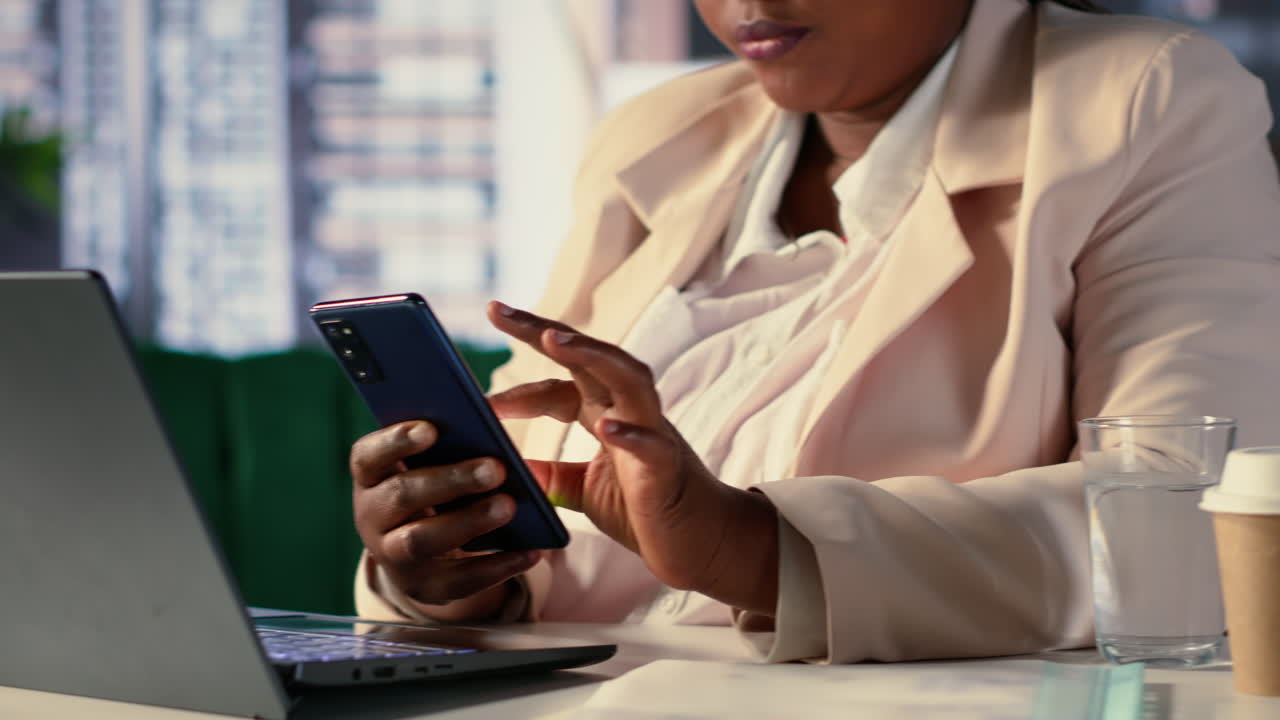 Businesswoman working with laptop and phone in office