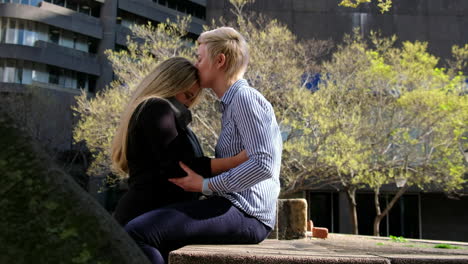 two-lesbian-gay-women-in-their-twenties-embrace-in-a-city-landscape-in-Cape-Town,-South-Africa