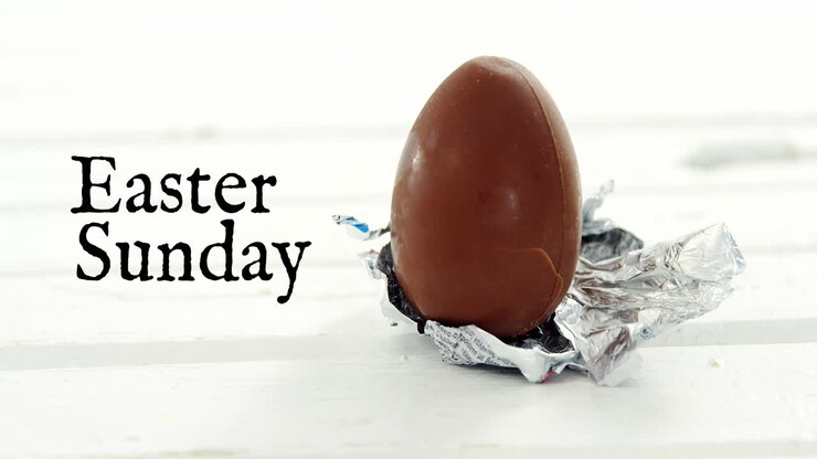 Animation of easter sunday over chocolate egg on white background