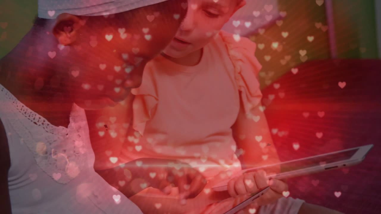 Older sister tapping tablet and guiding toddler through educational app navigation for learning