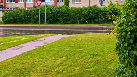 empty sidewalk and wet street on rainy day in residential suburban area