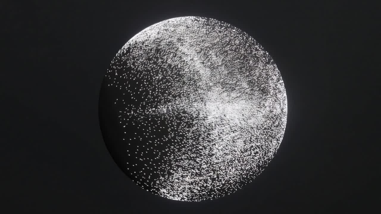 Growing particle cluster pushing white particles across dark sphere in studio, forming bright band
