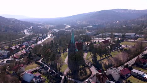 aerial cinematic shot of huge old church located in the small town