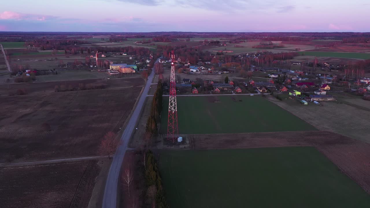 Internet tower near small town in distance aerial drone view
