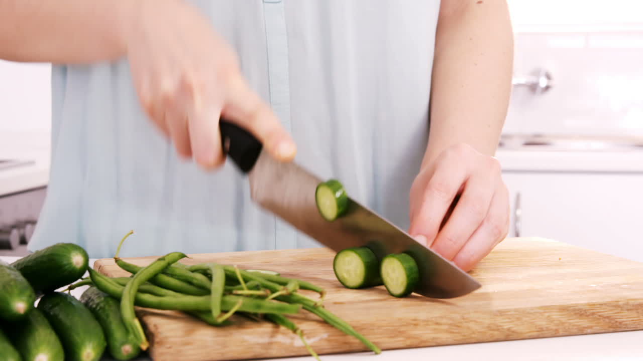 Woman cutting courgette 