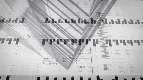 printed data sheet displaying charts under leaf shadows, highlighting grid and numeric details