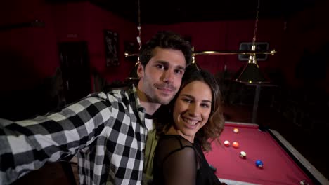 Delighted-couple-taking-selfie-in-bar