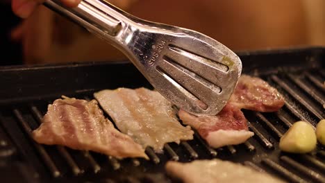 sizzling bacon and garlic cooked on a grill