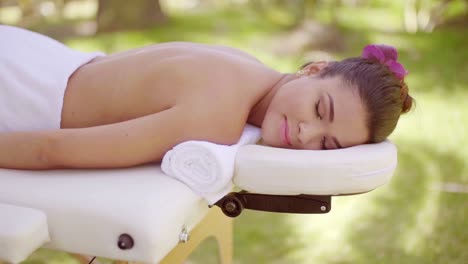 young woman enjoying an outdoor spa treatment