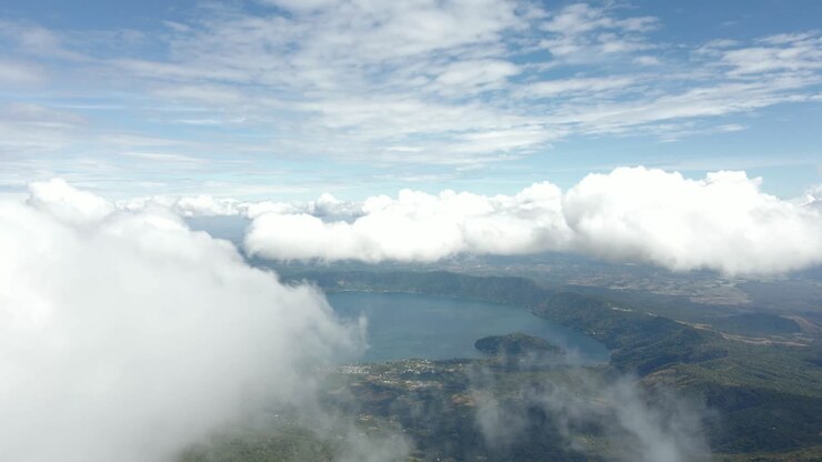 Coatepeque Caldera Lake with surrounding hills and fog, aerial view in El Salvador