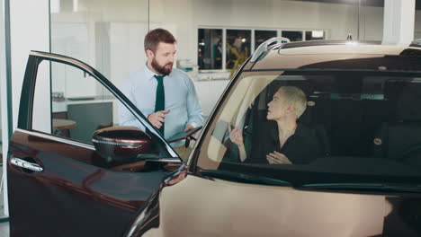 car salesman discussing vehicle with customer