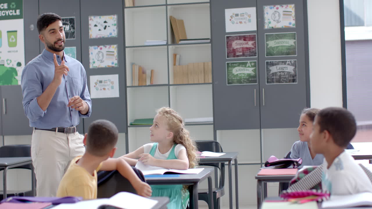 Young Asian man teaches in a vibrant school classroom