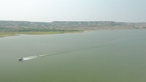 boating across the calm lake in saskatchewa landing, canada at daytime