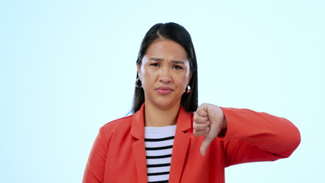 Thumbs-down,-upset-and-face-of-woman-in-a-studio