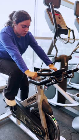 young woman doing spinning exercise at the gym