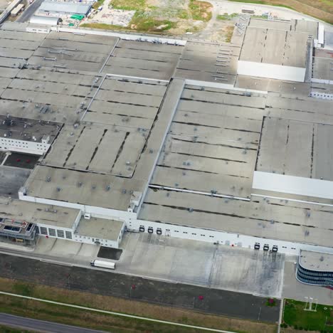 industrial complex. rooftops of industrial buildings with car parking on field. large factory from above. top view