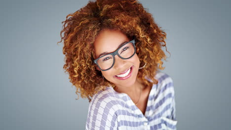 smiling woman with curly hair and glasses