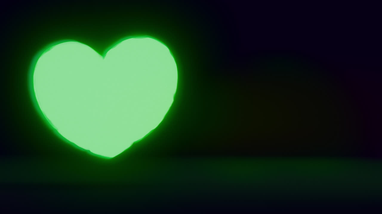 Green energy heart shapes on a dark background
