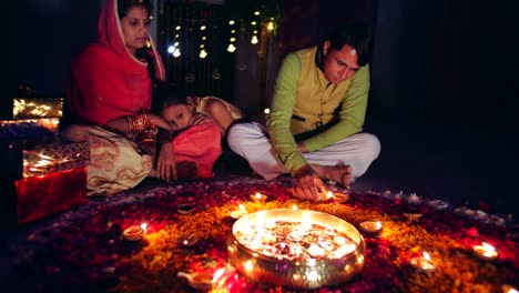 young parents with daughter celebrate decorate for diwali festival