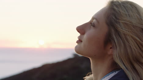 retrato de mulher feliz contemplando o futuro desfrutando de um estilo de vida despreocupado sentindo-se positiva relaxando olhando para o pôr do sol à beira-mar