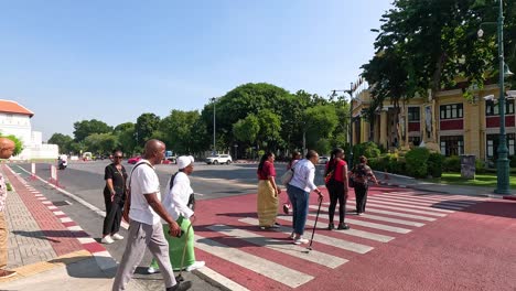 people crossing a street in bangkok, thailand