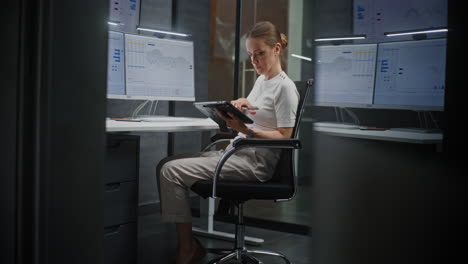 female financial analyst working on computer with multi-monitor workstation, monitoring real-time stocks and exchange market charts. successful businesswoman in financial agency office. vertical shot.