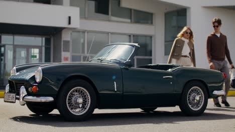 couple enjoying a vintage convertible