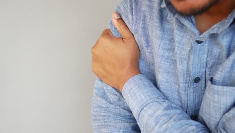 person experiencing shoulder pain or discomfort