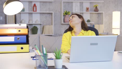 Una-Mujer-Joven-Que-Trabaja-En-Internet-Con-Una-Computadora-Portátil-En-La-Oficina-En-Casa-Está-Aburrida-Y-Agotada.