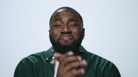 Portrait-of-smiling-african-giving-thanks-at-camera-on-grey-background.