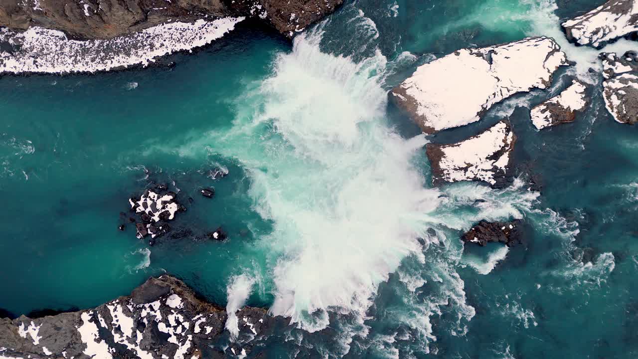 ascending cinematic aerial top down of scenic Waterfall of the Gods Goðafoss in Iceland , famous travel destination