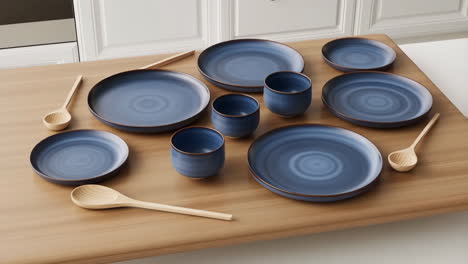 blue ceramic dinnerware set with wooden spoons on a wooden table