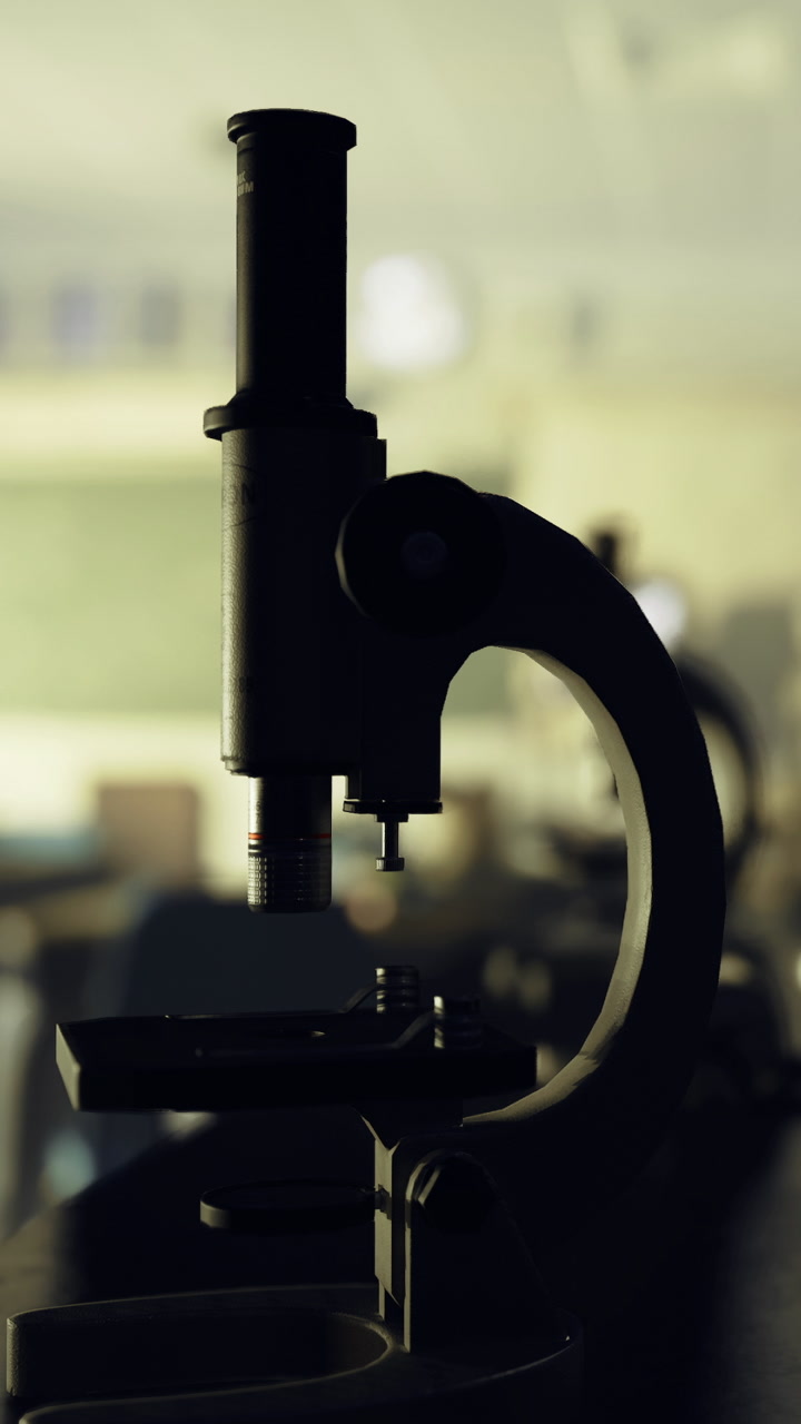 Close view of a microscope in a classroom setting at night