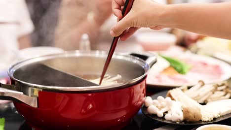 friends enjoy cooking hotpot together in bangkok