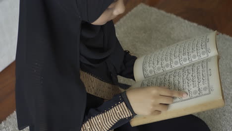 An-Asian-Muslim-woman-reciting-Salah-or-Salat-al-Fatiha-passage-of-the-Qur'an,-in-a-single-act-of-sujud-called-a-sajdah-or-prostrations-at-home