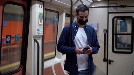 anonymous passenger chatting on smartphone while commuting on subway