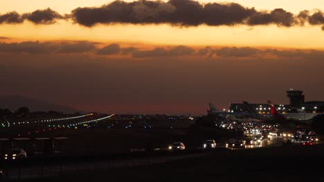 Beautiful-Shot-of-Traffic-Around-Juan-Santa-Maria-Internation-Airport-in-Costa-Rica-at-Dusk