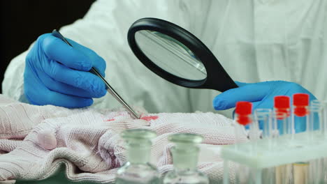 Crime-lab-worker-examines-evidence-on-clothes-7