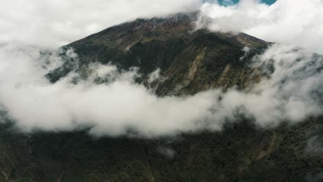 beautiful white clouds enveloping tungurahua volcano above baños de agua santa in ecuador