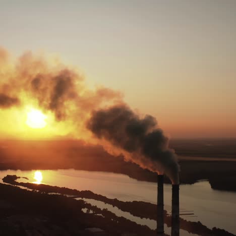 Smoking industrial zone factory chimneys. Aerial view of plant and smoke coming from chimney