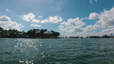 view from the starboard side of a small watercraft as it travels the waterways of miami florida