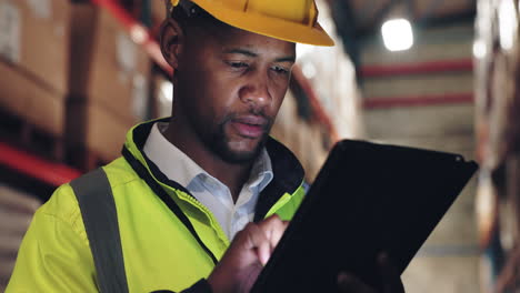 warehouse worker using a tablet to manage inventory