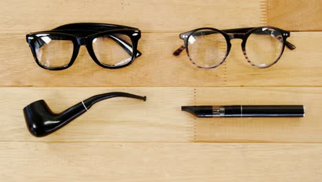 spectacles, smoking pipe and cigar on table