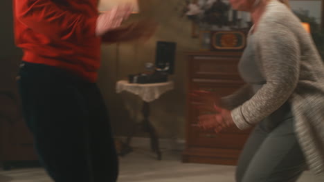 happy senior couple dancing at home