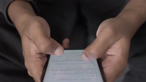 asian adult hands holding and browsing smartphone